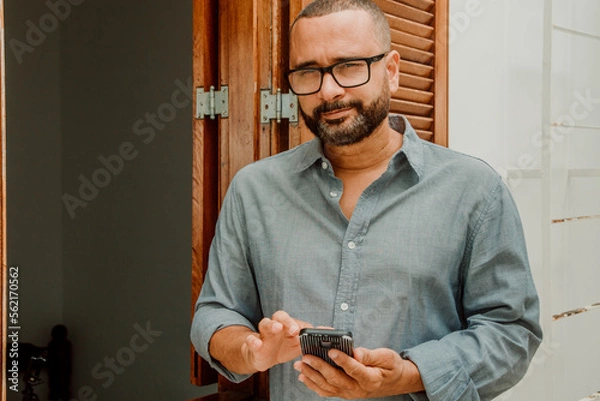 Fototapeta Portrait of brazilian man using cellphone