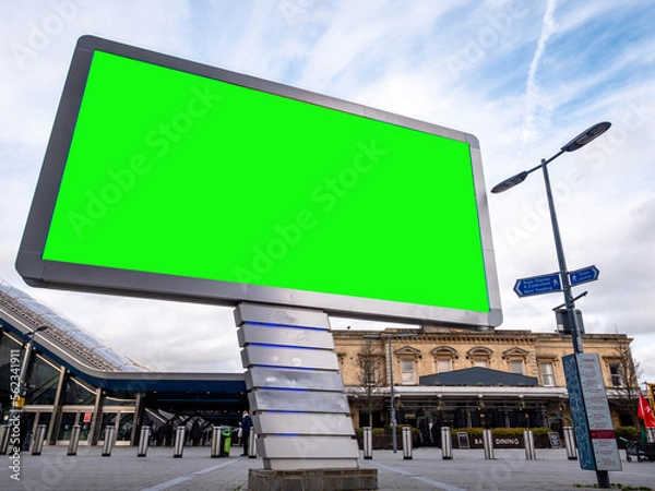 Obraz Large Green Screen Advertising Board - City Street scene showing high street and transport hub with billboard for targeted ads towards commuters and shoppers