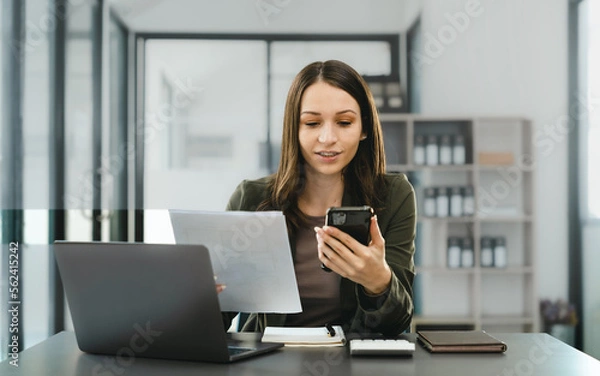Fototapeta Attractive caucasian business woman top manager working with laptop tablet cojmputer planning financial strategy analyst and global stock market and sector indices trading data.