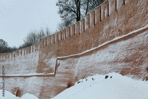 Obraz snow covered old red bricks wall of castle