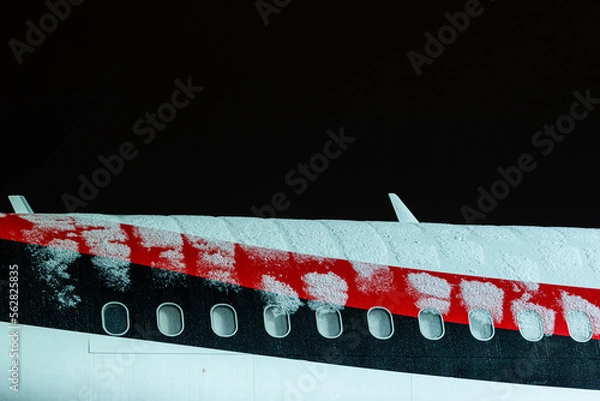 Fototapeta This photo shows a icy plane fuselage, this can be dangerous as icing can cause a plane crash. This plane has to be deiced before take off
