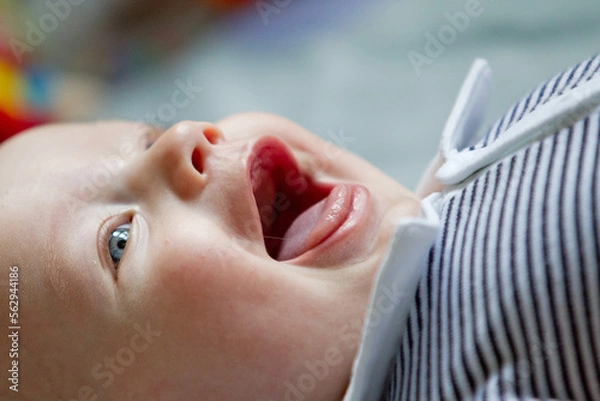 Obraz Closeup indoor portrait of a cute happy toddler boy with blue eyes