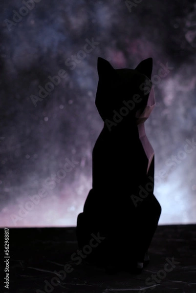 Fototapeta Black cat silhouette over blur starry background. Vertical orientation