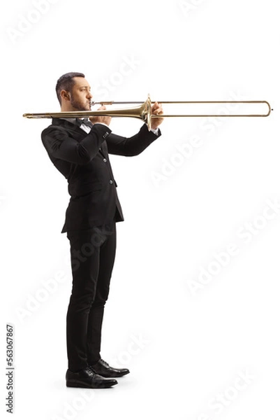 Fototapeta Full length profile shot of an elegant male musician playing a trombone