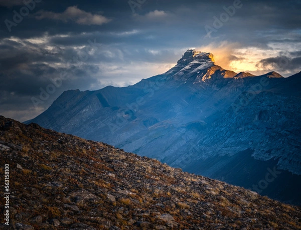 Obraz Light and storm clouds on mountain peak