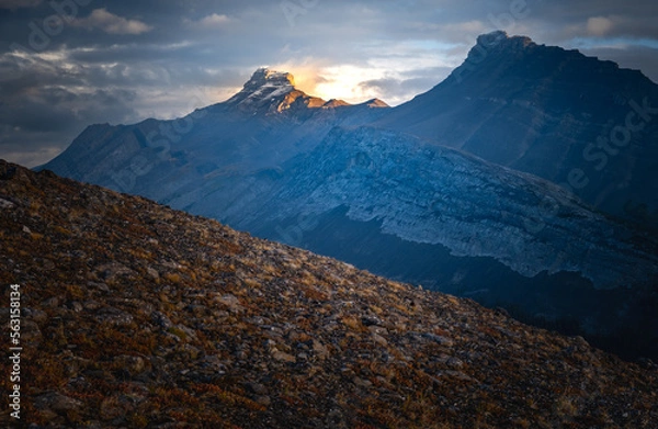 Obraz Light and storm clouds on mountain peak