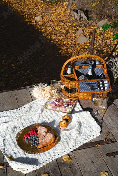 Fototapeta Picnic by the lake during autumn with vibrant foliage and a serene atmosphere