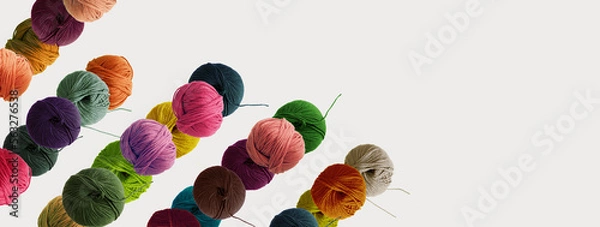 Fototapeta Balls of wool colored yarn for hand knitting and crochet on white background.  Diagonal pattern.  Recomforting hobby for cold winter concept. Mock up, flat lay, copy space, banner.