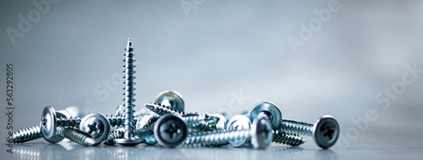 Fototapeta A bunch of self-tapping screws on the table. 