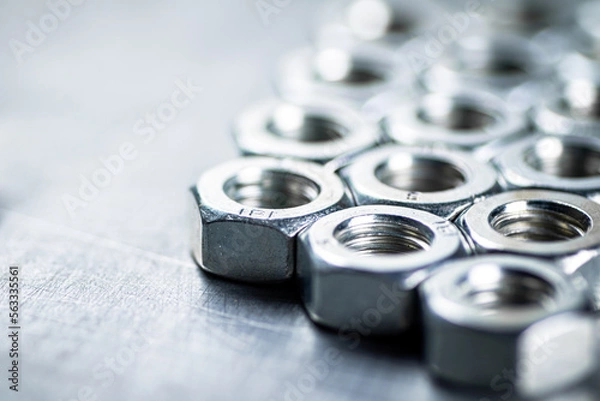 Obraz Working tool. Metal nuts on the table. 