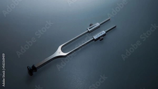 Fototapeta tuning fork C 128 on a grey background with gradation, medical instruments, equipment