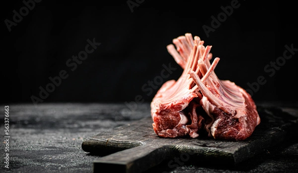 Fototapeta Raw rack of lamb on a cutting board on the table. 