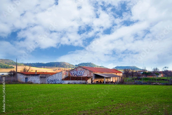 Obraz Beautiful landscape scenery with meadow and old farm house under cloudy sky Europe Spain