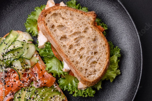 Obraz Fresh tasty sandwich with salmon, avocado and sesame and flax seeds
