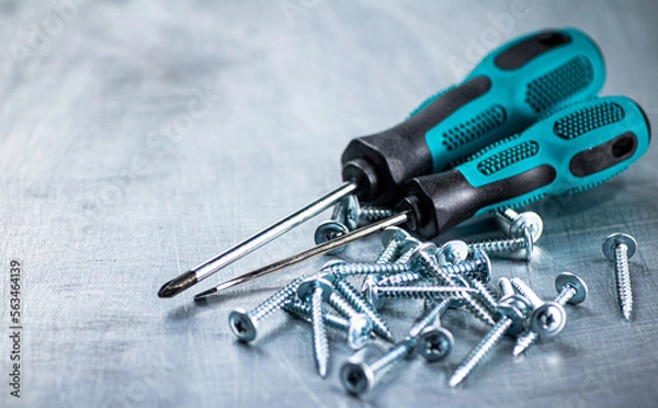 Fototapeta Screwdrivers with self-tapping screws on the table.