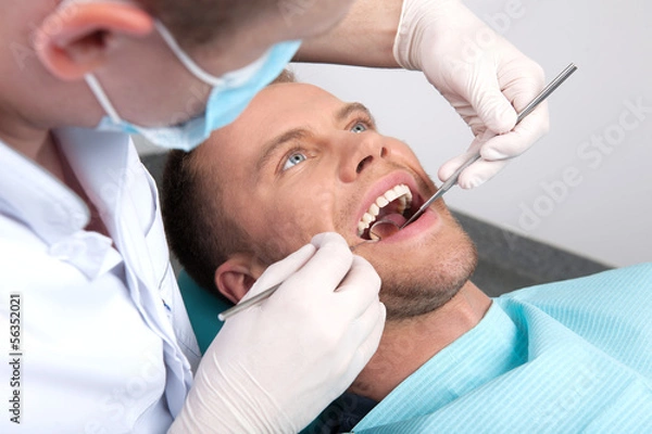 Obraz Patient at dentist office. Top view of man sitting at the chair