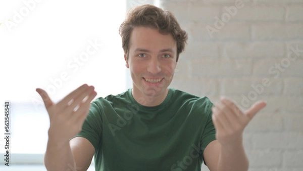 Obraz Inviting Young Man Pointing at the Camera