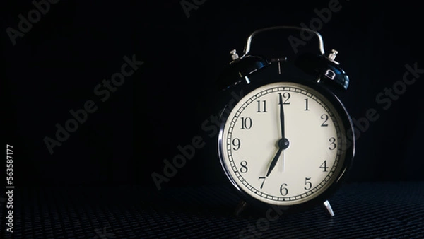 Fototapeta Background photo of an alarm clock showing 7:00