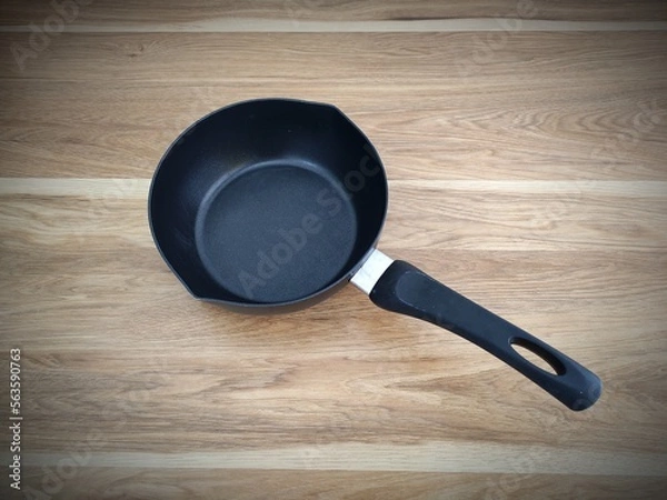 Obraz pan on wood table