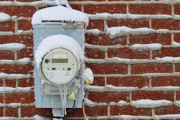 Obraz Electricity meter outside a building in winter, with snow and ice