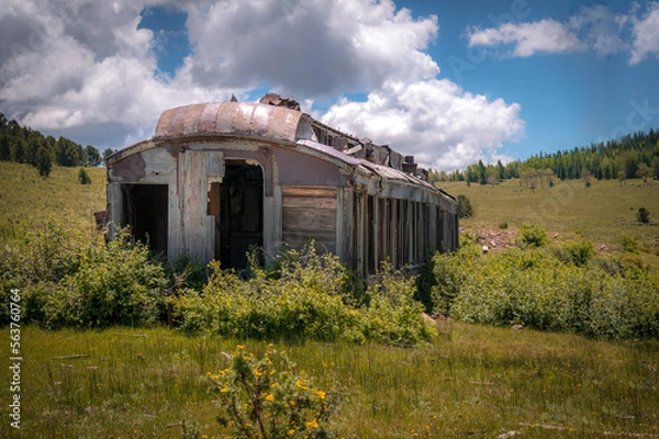 Fototapeta Abandoned train diner car near the mountains