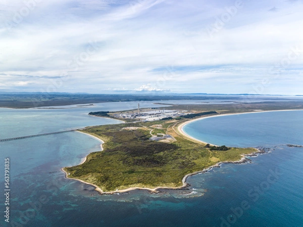 Fototapeta High angle aerial drone view of Tiwai Point peninsula at the entrance to Bluff Harbour on the southern coast of the South Island of New Zealand. It is known for a large industrial aluminium smelter.