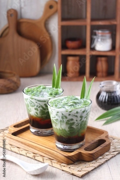 Fototapeta Cendol is an iced sweet dessert that contains droplets of green rice flour jelly, coconut milk and palm sugar syrup. It is commonly found in Indonesia, Malaysia, Brunei, Cambodia, and Singapore