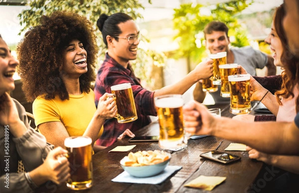 Fototapeta Young people drinking and toasting beer pint at brewery bar restaurant - Beverage life style concept with happy friends having fun together at brew garden