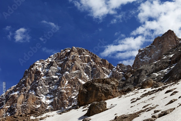 Fototapeta Rocks with snow at nice spring day