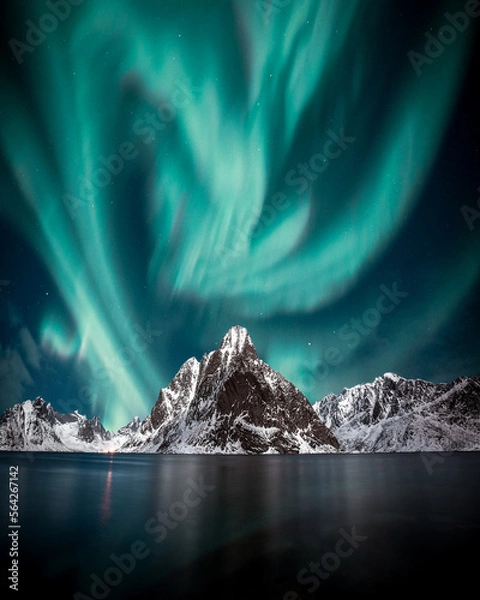 Fototapeta Northern lights, Aurora borealis over amazing landscape in Lofoten, Norway  with mountains in background, Absolutely stunning and beautiful lights on the sky