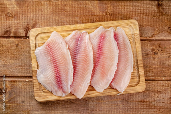 Fototapeta Fresh fish fillet on a cutting board. 