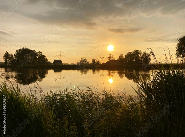 Obraz sunset over a pond