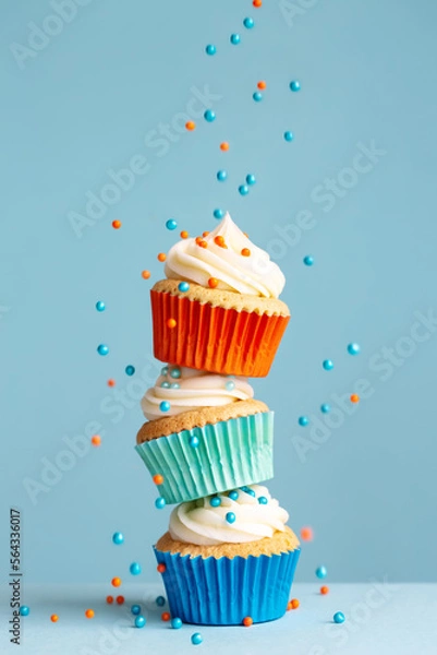 Obraz Stack of cupcakes with falling sprinkles