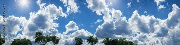 Obraz Bright blue skies and fluffy white clouds on a bright and sunny day - A panoramic view of the sky made by generative AI