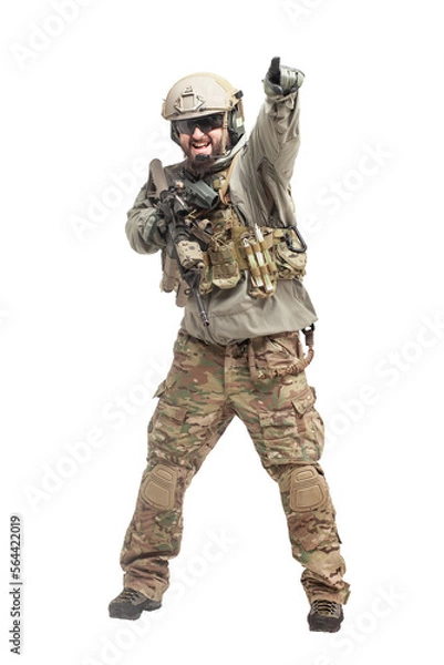 Fototapeta American soldier in military equipment with a rifle attacks on a white background, a commando with weapons in uniform, a ranger in action