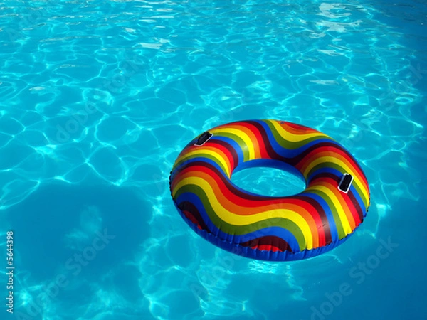 Obraz Swimming pool with a brightly coloured inflatable ring.