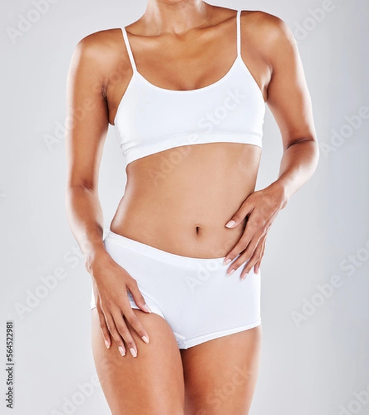 Fototapeta Fitness health, wellness and body of woman in studio after workout, exercise and training to lose weight. Motivation, skincare and abdomen of female model for nutrition, diet routine and slim figure
