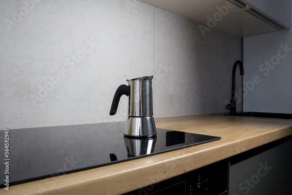 Fototapeta a geyser coffee machine brews at home on an induction stove