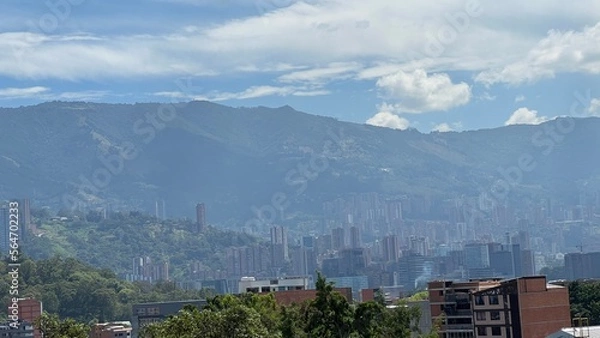 Fototapeta panorama of the city of medellin and mountains with ble clear sky