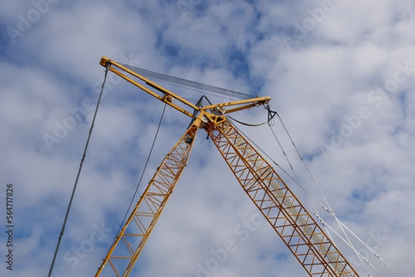 Fototapeta Selective focus view at yellow construction crane. 