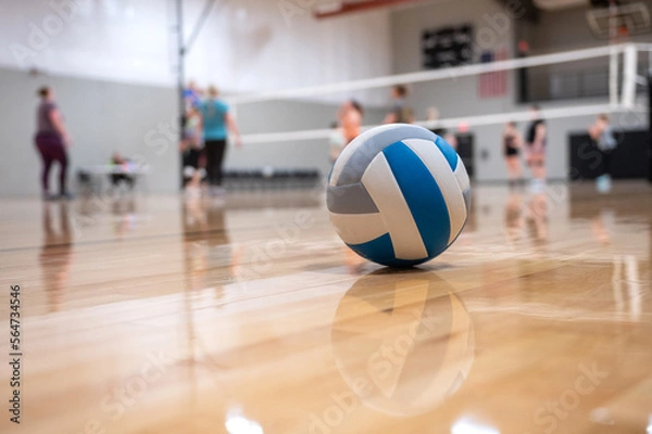 Fototapeta volleyball on the floor with people in the background