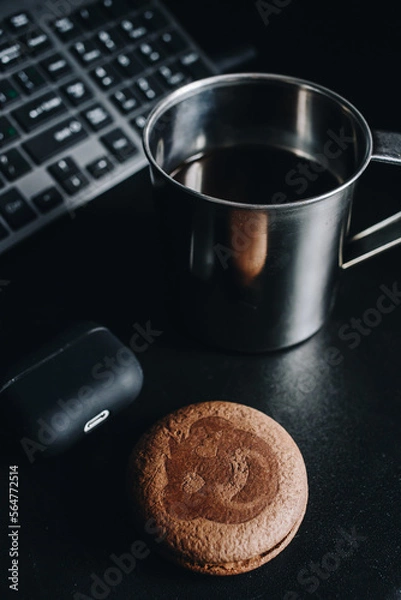 Fototapeta Morning coffee and cookies by the computer keyboard and headphones