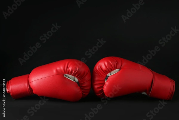 Fototapeta Red boxing gloves on black marble table. Competition concept