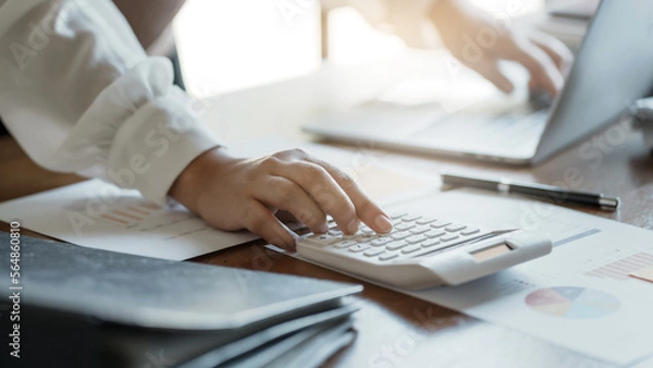 Fototapeta Business Professional Chartered Accountant Woman working with computer and calculator Sales Invoice Accounting