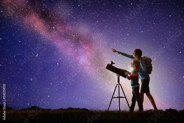 Fototapeta Man and child looking at stars through telescope
