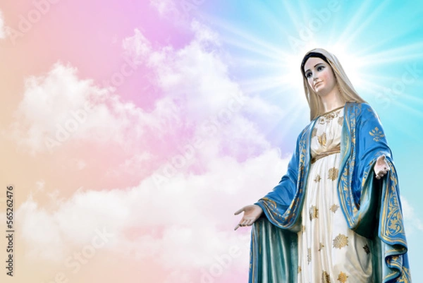 Fototapeta Statue of Our lady of grace virgin Mary with beautiful Sky Pastel with abstract colored background and wallpaper in sweet color. at Thailand.