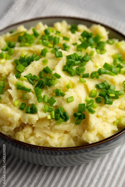 Fototapeta Homemade Mashed Potatoes with Chives in a Bowl, side view. Close-up.