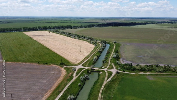 Obraz Turning the irrigation canal with the bridge among the fields. High quality FullHD footage