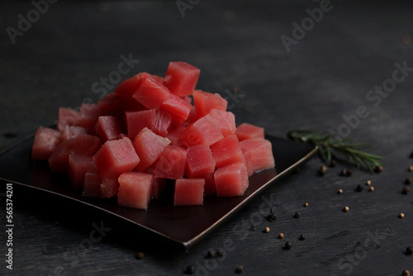 Fototapeta Raw fresh tuna cube on black plate