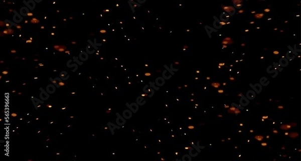 Fototapeta sparks like particles floating in air over black background